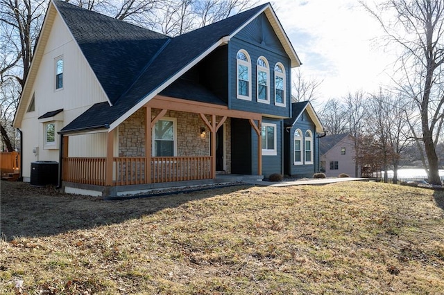 view of front of home featuring a porch, cooling unit, and stone siding