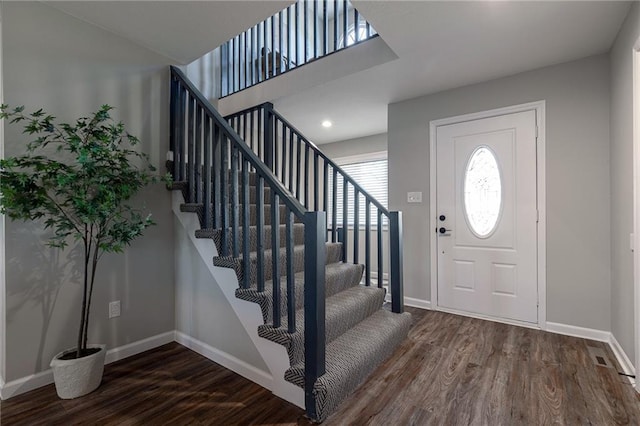 entrance foyer featuring stairway, wood finished floors, and baseboards