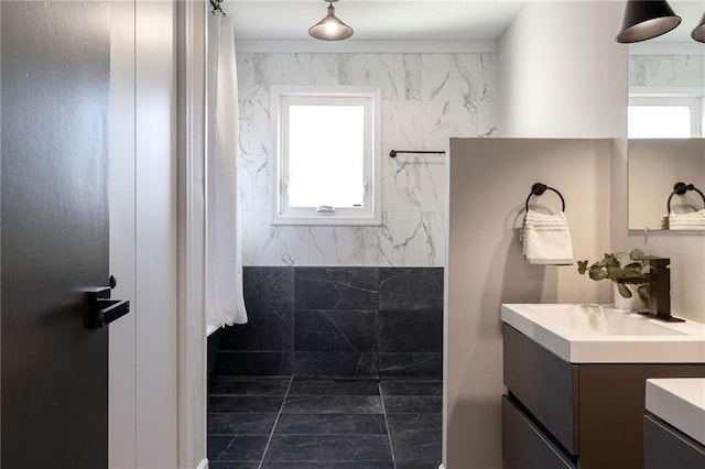 bathroom featuring walk in shower and vanity