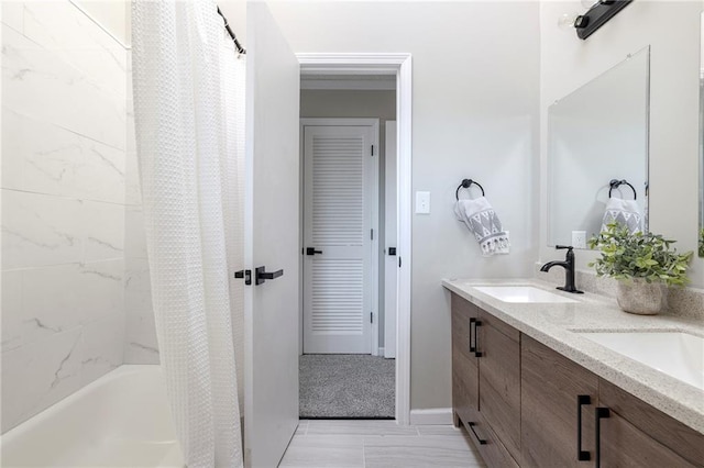 full bath with double vanity, a sink, and shower / bathtub combination with curtain