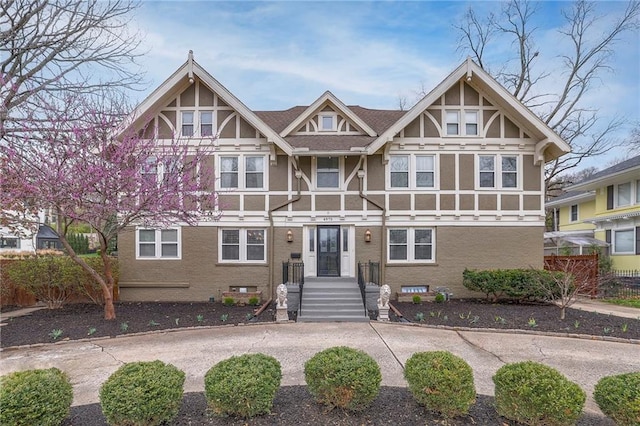 view of front of house with stucco siding and brick siding