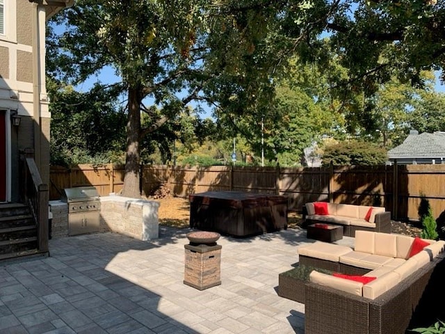 view of patio featuring area for grilling, a grill, an outdoor hangout area, and a fenced backyard