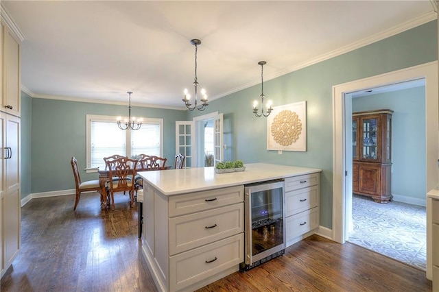 kitchen featuring dark wood-type flooring, beverage cooler, light countertops, and a chandelier