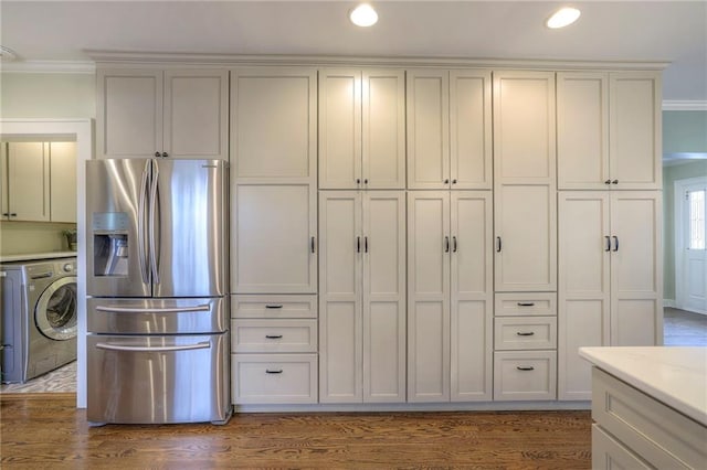 kitchen featuring washer / clothes dryer, dark wood-style floors, stainless steel refrigerator with ice dispenser, and ornamental molding