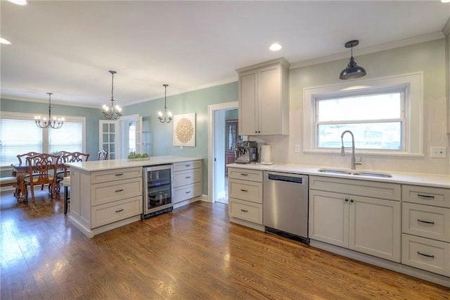 kitchen with dark wood-type flooring, beverage cooler, a sink, light countertops, and dishwasher