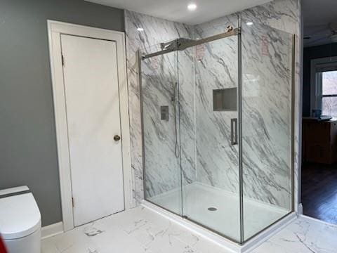 full bath featuring a marble finish shower, toilet, and marble finish floor