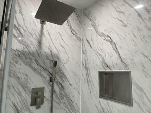 details featuring a marble finish shower