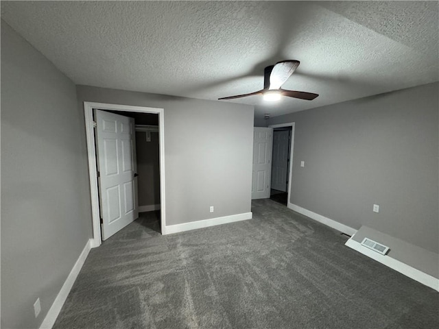 415 E Hale St, Spring Hill, KS 66083 - unfurnished bedroom with dark carpet, a textured ceiling, and a ceiling fan
