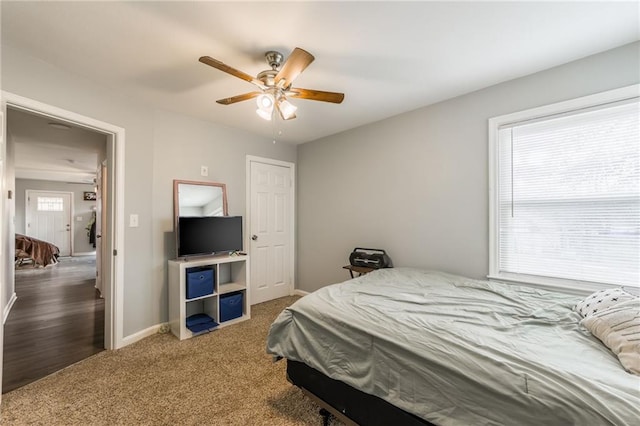 carpeted bedroom featuring a ceiling fan and baseboards