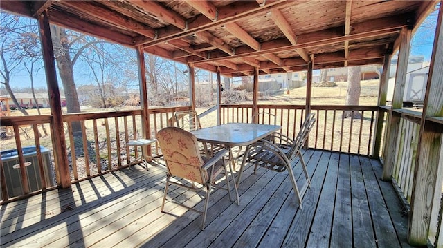 wooden deck with central AC unit and outdoor dining space