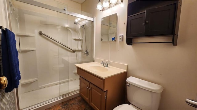 full bathroom with vanity, toilet, and a stall shower