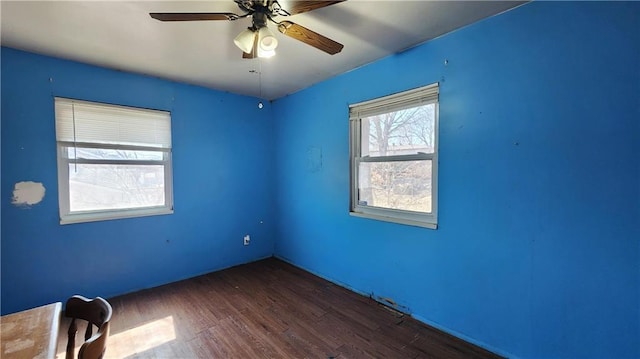 empty room featuring dark wood finished floors and a ceiling fan