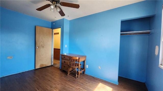 unfurnished bedroom with a closet, visible vents, ceiling fan, and wood finished floors