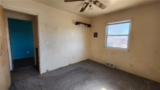 carpeted empty room with visible vents and ceiling fan