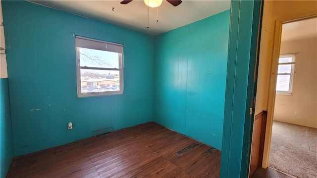 empty room with wood finished floors and ceiling fan