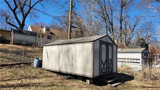 view of shed with cooling unit and fence