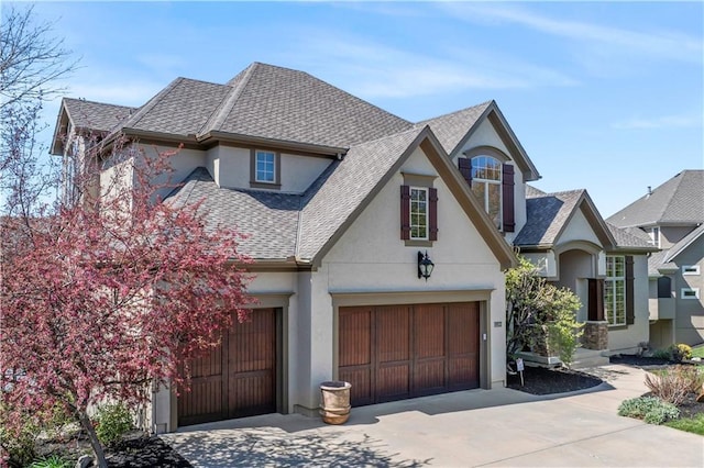 15300 Mastin St, Overland Park, KS 66221 - view of front facade featuring stucco siding, a shingled roof, and concrete driveway
