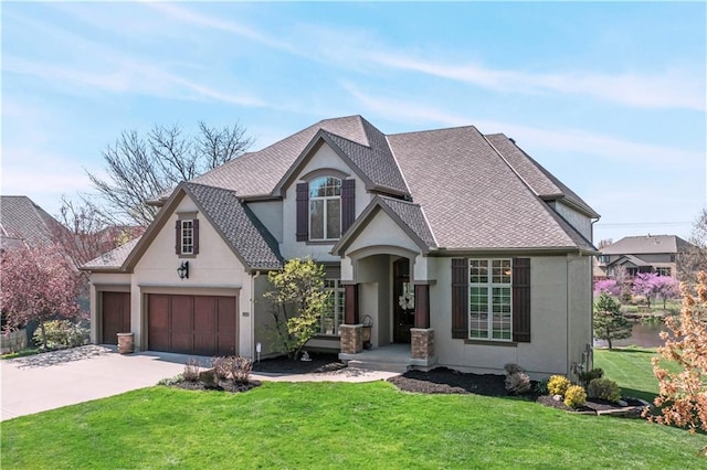 15300 Mastin St, Overland Park, KS 66221 - view of front facade with concrete driveway, roof with shingles, stucco siding, a front yard, and a garage
