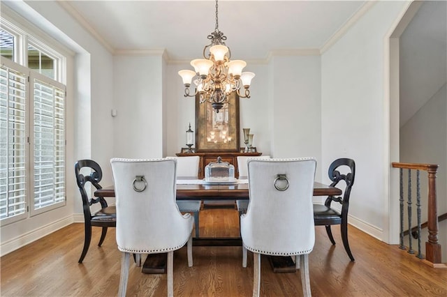 15300 Mastin St, Overland Park, KS 66221 - dining area featuring wood finished floors, an inviting chandelier, baseboards, and ornamental molding