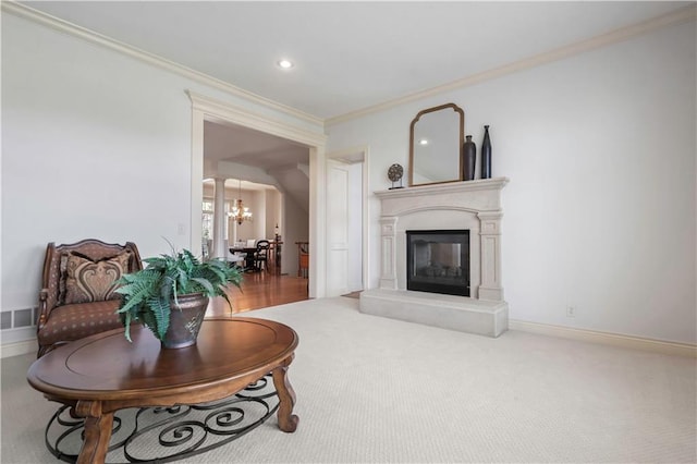 15300 Mastin St, Overland Park, KS 66221 - carpeted living area featuring visible vents, baseboards, an inviting chandelier, ornamental molding, and a glass covered fireplace