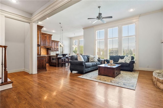 15300 Mastin St, Overland Park, KS 66221 - living room featuring crown molding, a ceiling fan, recessed lighting, wood finished floors, and baseboards