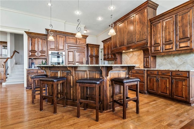15300 Mastin St, Overland Park, KS 66221 - kitchen featuring stainless steel oven, backsplash, paneled fridge, and light wood-type flooring