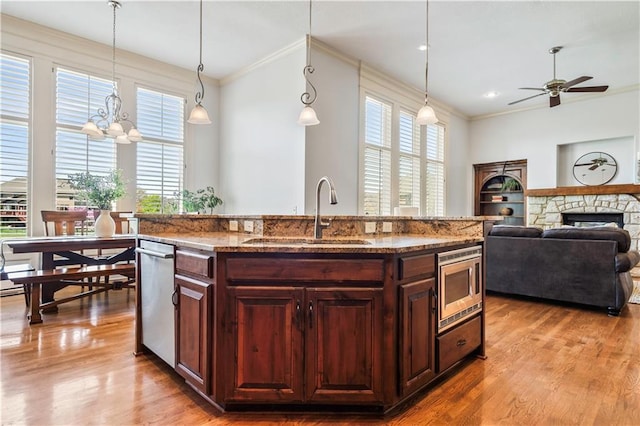 15300 Mastin St, Overland Park, KS 66221 - kitchen featuring stainless steel microwave, a sink, crown molding, and wood finished floors