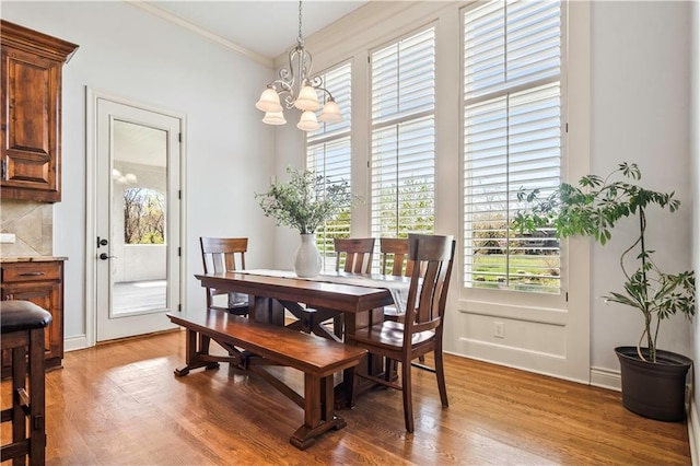 15300 Mastin St, Overland Park, KS 66221 - dining room with light wood-style flooring, crown molding, a notable chandelier, and baseboards