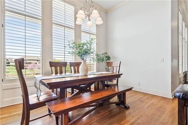 15300 Mastin St, Overland Park, KS 66221 - dining room with a notable chandelier, light wood-style floors, baseboards, and crown molding