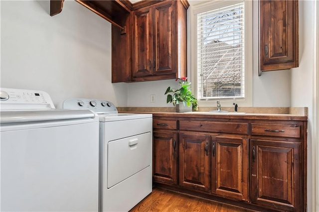 15300 Mastin St, Overland Park, KS 66221 - clothes washing area featuring cabinet space, separate washer and dryer, wood finished floors, and a sink