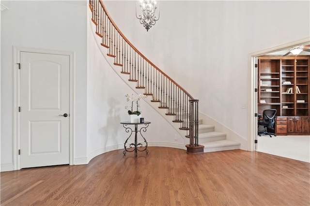 15300 Mastin St, Overland Park, KS 66221 - staircase with baseboards, a high ceiling, and wood finished floors