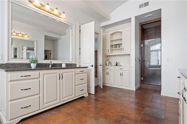 15300 Mastin St, Overland Park, KS 66221 - full bathroom featuring a sink, visible vents, two vanities, and a tile shower