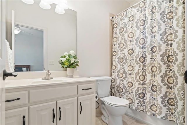 15300 Mastin St, Overland Park, KS 66221 - full bathroom with vanity, a ceiling fan, toilet, tile patterned floors, and shower / bath combo with shower curtain