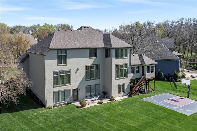 15300 Mastin St, Overland Park, KS 66221 - rear view of house featuring basketball court, stucco siding, stairs, a patio area, and a lawn