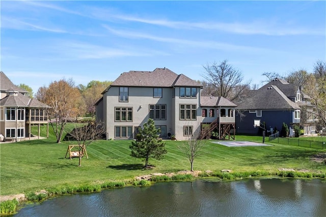 15300 Mastin St, Overland Park, KS 66221 - rear view of property featuring a water view, stucco siding, a yard, and stairs