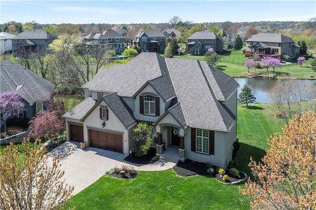 15300 Mastin St, Overland Park, KS 66221 - view of front of home featuring roof with shingles, driveway, stucco siding, and a front lawn