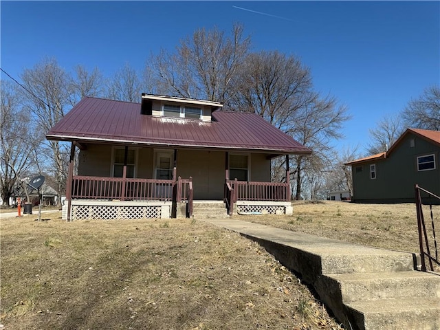 view of front of property featuring covered porch and metal roof