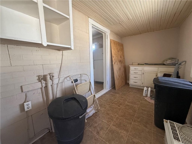 bathroom with wooden ceiling and tile patterned floors