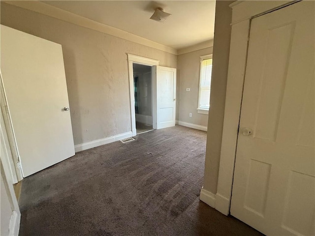 unfurnished bedroom with baseboards, visible vents, and carpet flooring