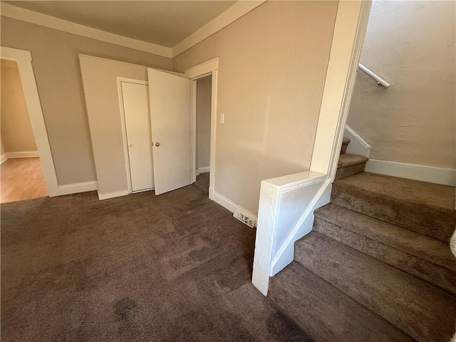 interior space with carpet flooring and baseboards