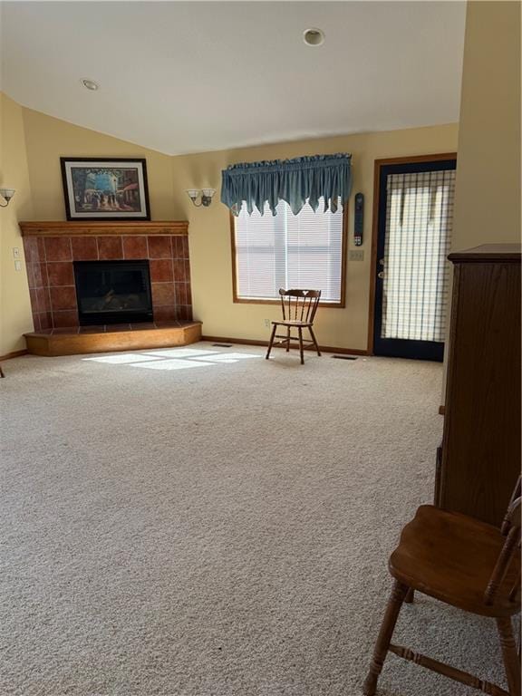 carpeted living area featuring recessed lighting, baseboards, vaulted ceiling, and a tile fireplace