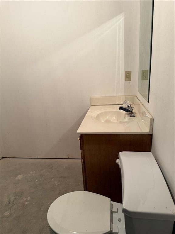 half bathroom with toilet, unfinished concrete flooring, and vanity