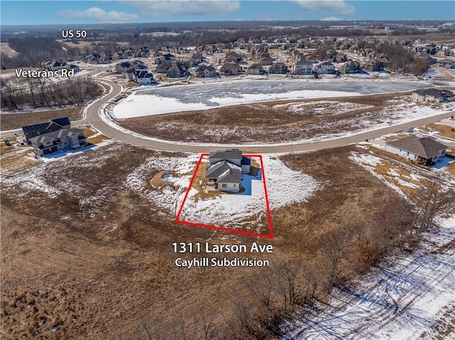 snowy aerial view with a residential view