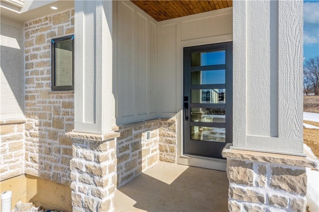 doorway to property with stone siding