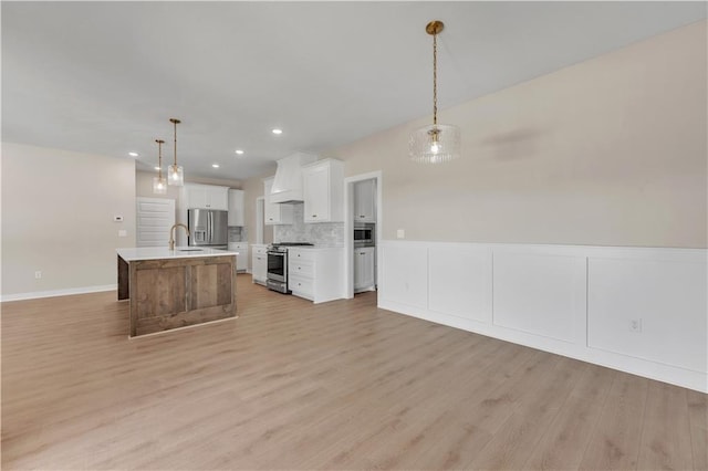 kitchen featuring appliances with stainless steel finishes, light countertops, open floor plan, and custom range hood