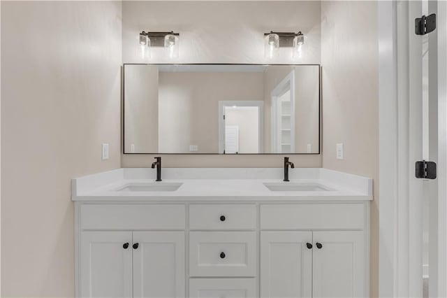 full bathroom featuring double vanity and a sink