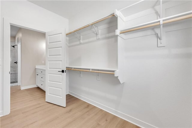 walk in closet featuring light wood-style flooring