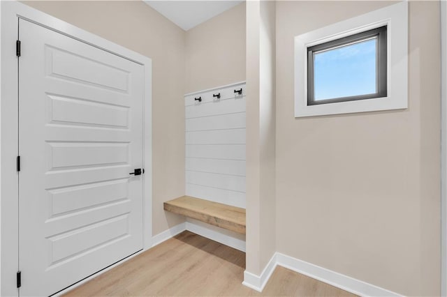 mudroom with light wood-style floors and baseboards