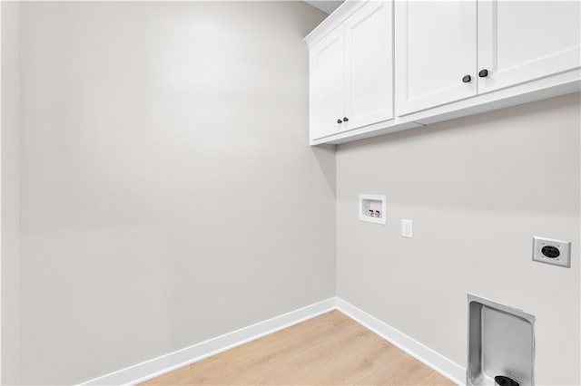 washroom with cabinet space, baseboards, hookup for an electric dryer, light wood-type flooring, and washer hookup