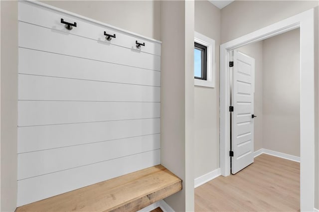 mudroom with light wood finished floors and baseboards